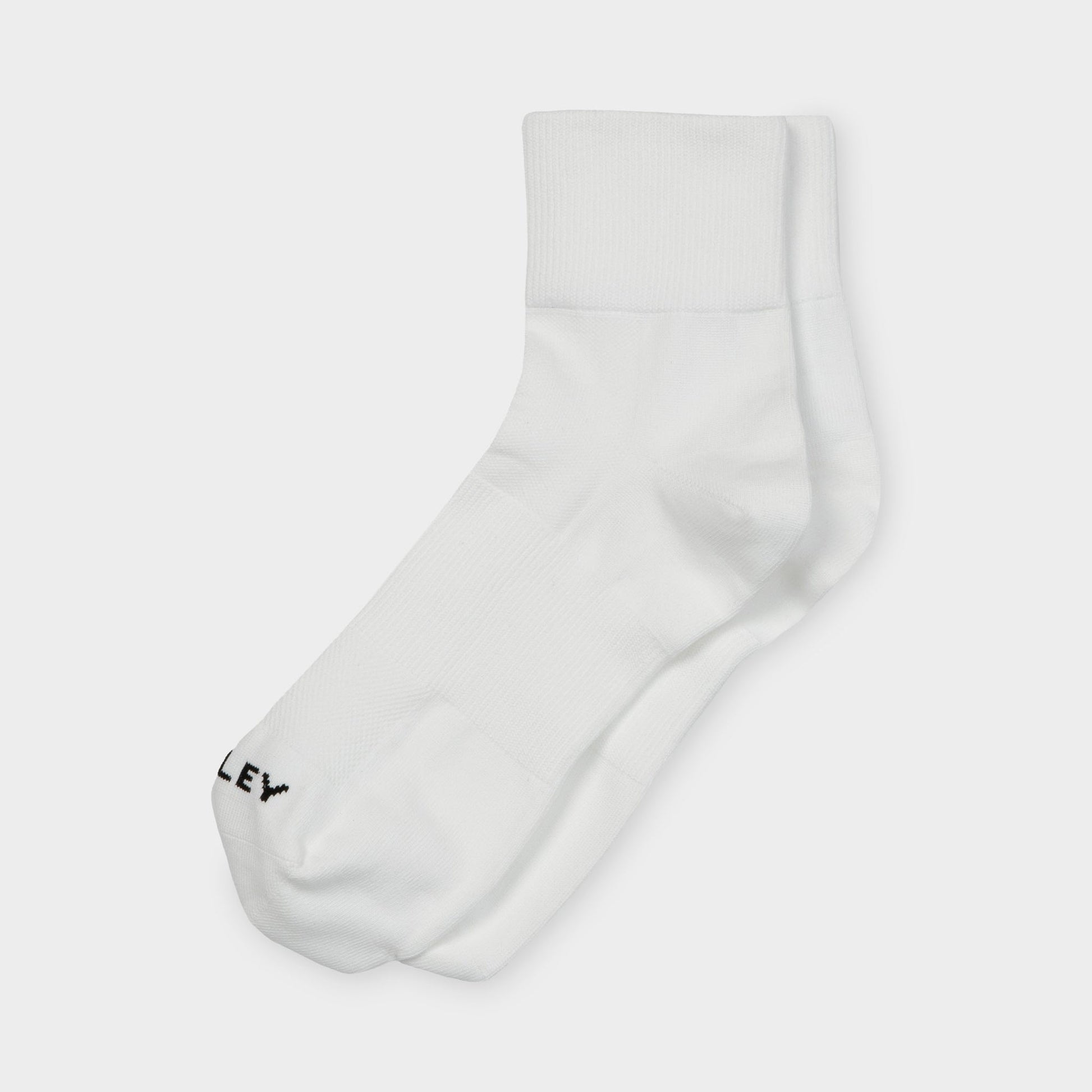 Tilley Ankle Travel Sock by Tilley: white crew socks with arch support and black text near the toe.