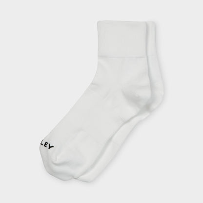 Tilley Ankle Travel Sock by Tilley: white crew socks with arch support and black text near the toe.