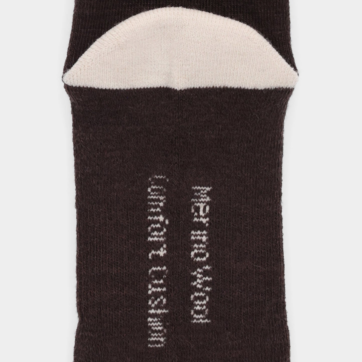 Close-up of Tilley Landscape Sock—ONLINE ONLY; dark merino with white toe and odour eliminating text.