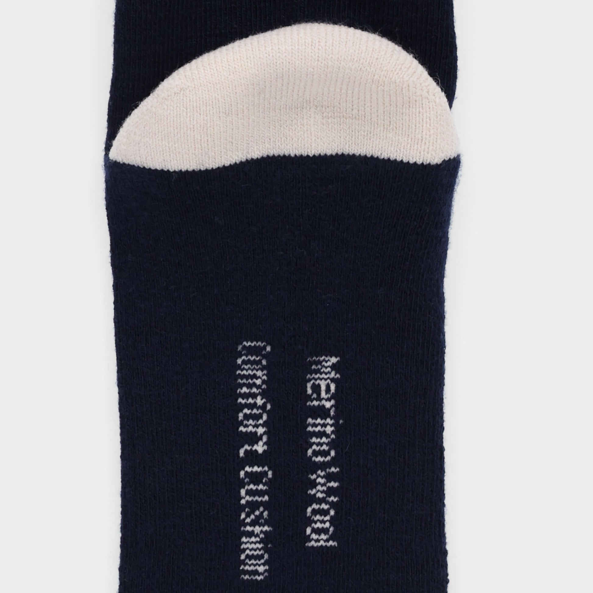 Close-up of Tilley Landscape Sock - ONLINE ONLY in navy blue with white toe and vertical moisture wicking text.