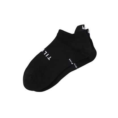 The Tilley Tab Travel Sock in black by Tilley, no-show style with white text, shown on white background.