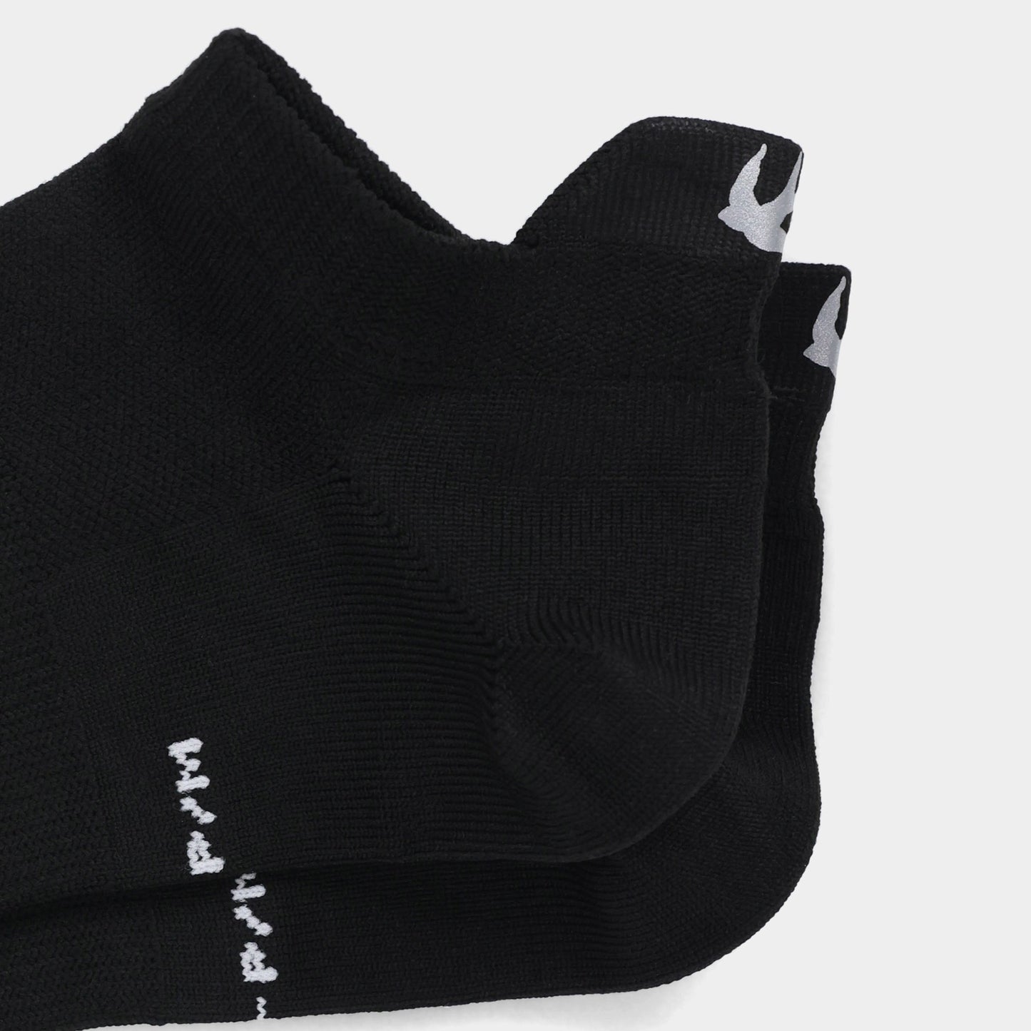 Tilley Tab Travel Sock: Black ankle socks with arch support, bird logo, and moisture-wicking fabric.