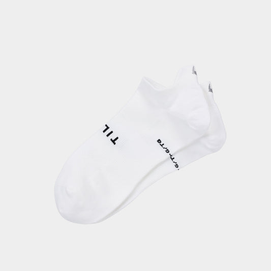 Product Image – Tilley Tab Travel Sock - ONLINE ONLY: White ankle socks with arch support and black text near the toes by Tilley.