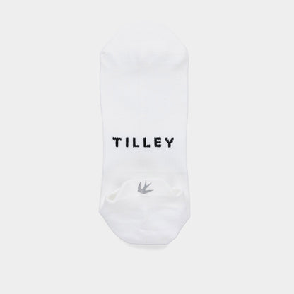The Tilley Tab Travel Sock is a white ankle sock with arch support, black “TILLEY,” and a small bird logo.