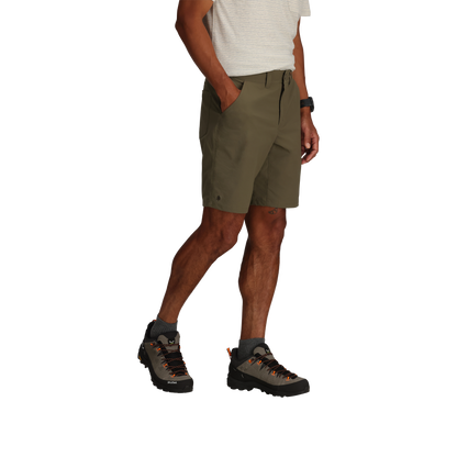 Man wearing Royal Robbins Wilder Shorts and boots, standing against a white background.