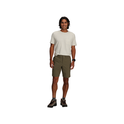 Man standing and smiling, wearing a light t-shirt, Royal Robbins Men's Wilder Shorts, and boots on a plain background.