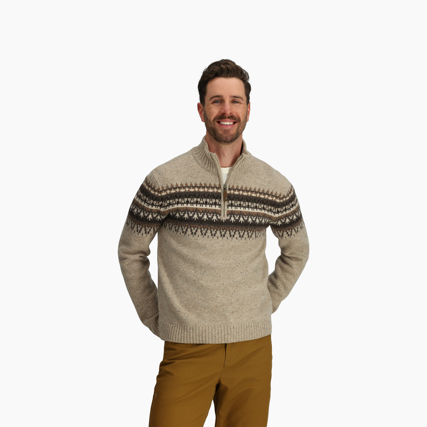 Man wears Royal Robbins Men's Arch Rock 1/4 Zip in beige, standing with hands behind back against a white background.