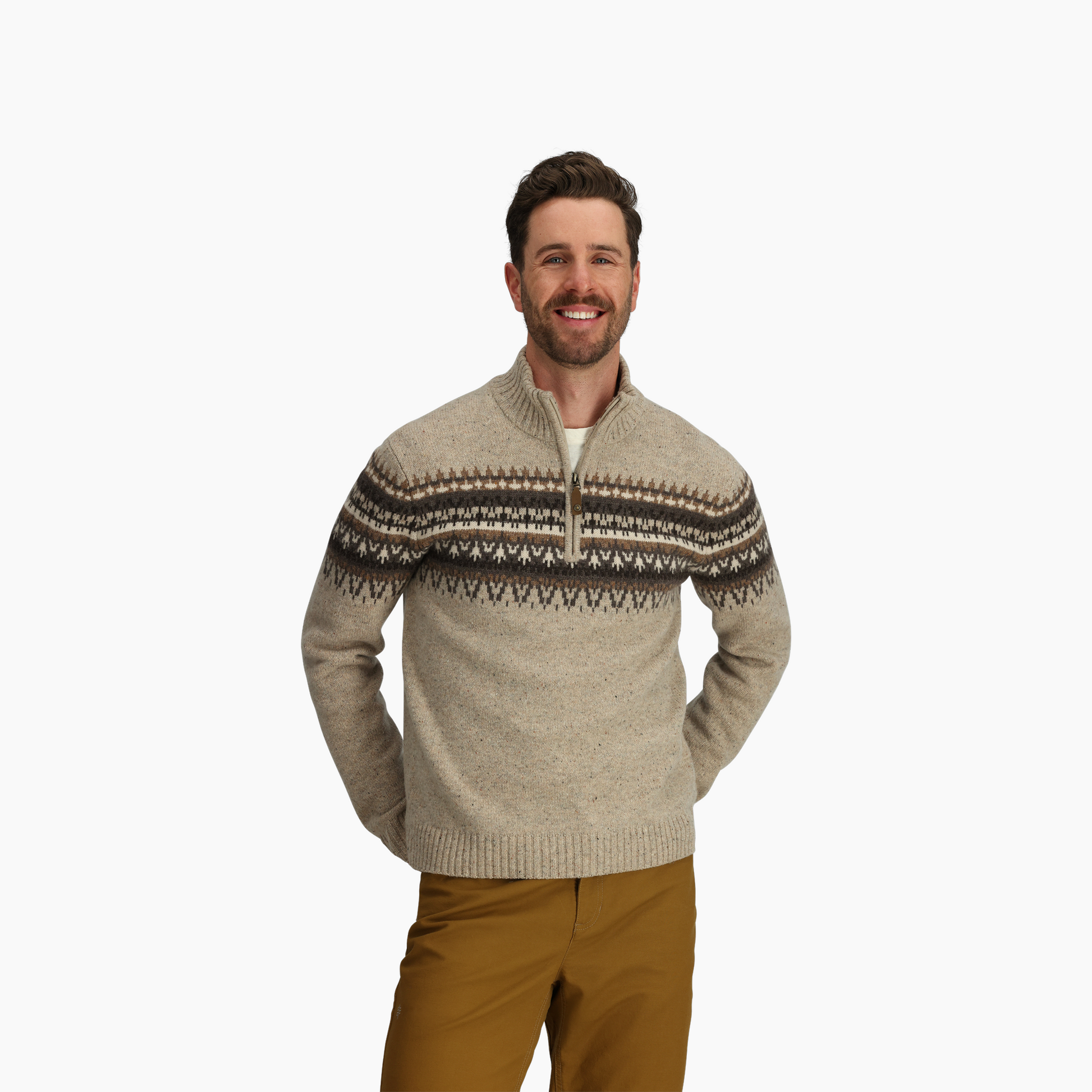Man wears Royal Robbins Men's Arch Rock 1/4 Zip in beige, standing with hands behind back against a white background.