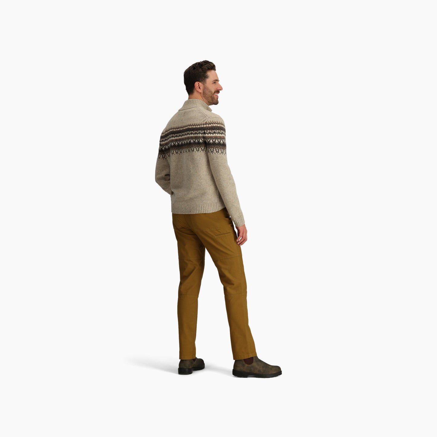 Man facing left wears Royal Robbins Men's Arch Rock 1/4 Zip sweater, mustard pants, and dark shoes on white.