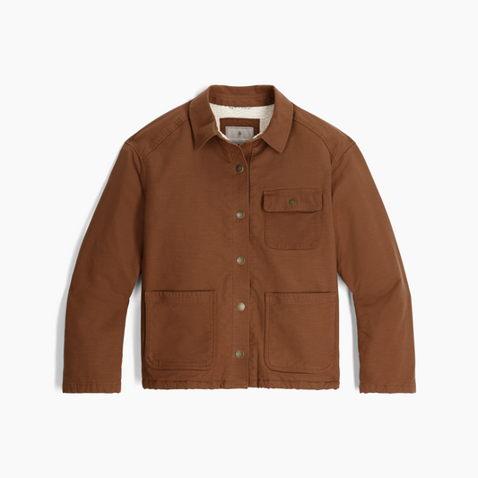 Product Image – Royal Robbins Women's El Cap Canvas Shacket in brown, with 3 front pockets and collar, shown flat on white.