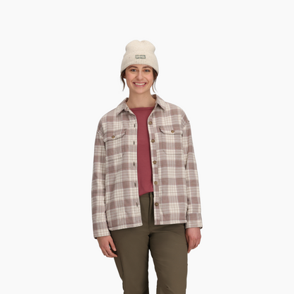 Woman wearing Royal Robbins Women's Vista Flannel Shacket, cream beanie, maroon shirt, and olive pants.
