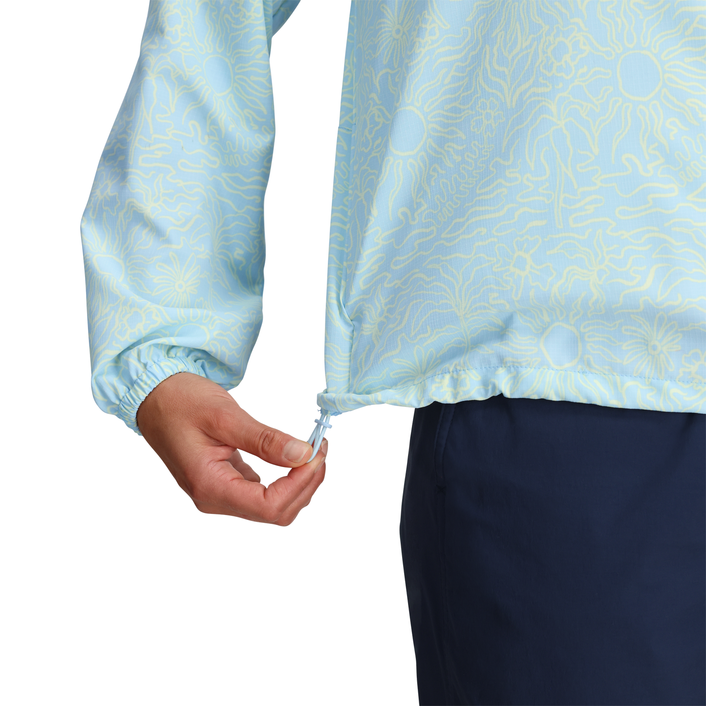 Woman adjusts drawstring hem of Royal Robbins Women's Salathe Sun Hoodie with UPF40+; dark blue pants visible.