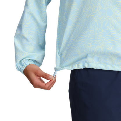 Woman adjusts drawstring hem of Royal Robbins Women's Salathe Sun Hoodie with UPF40+; dark blue pants visible.