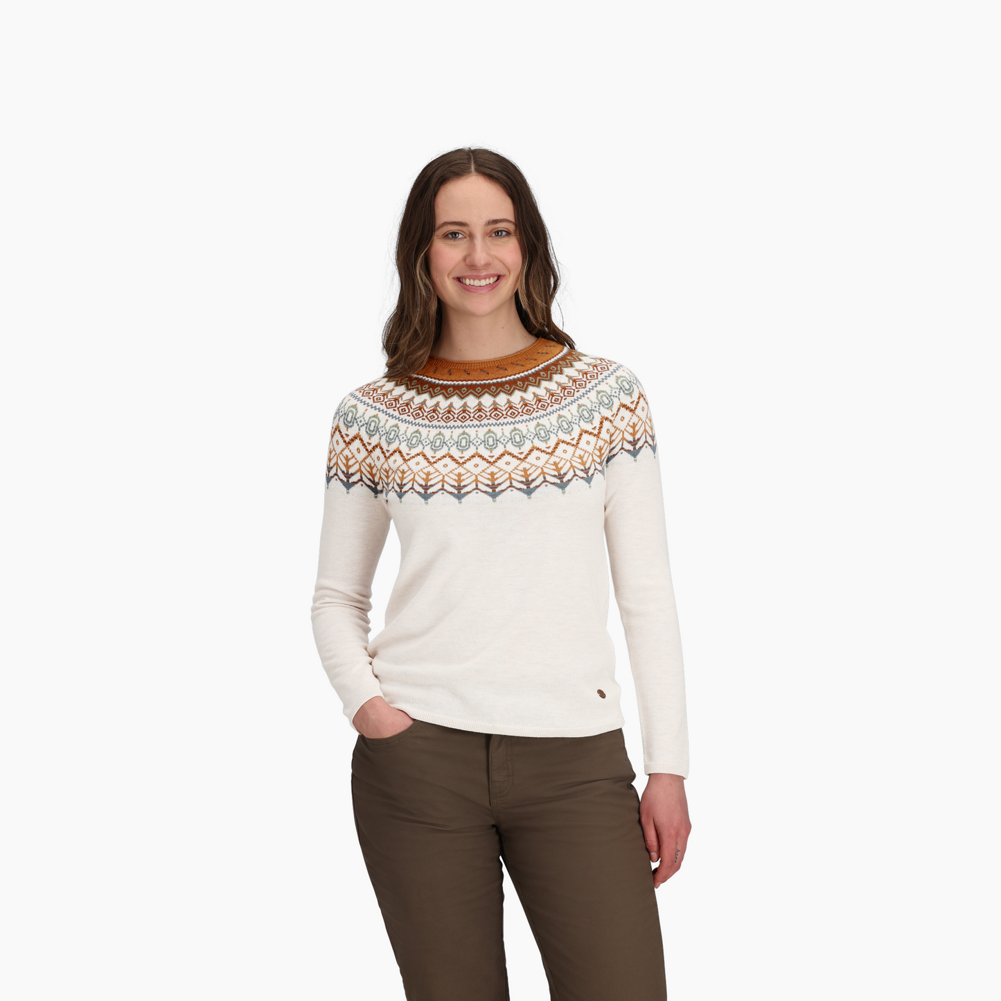 Woman smiling in the Royal Robbins Women's Westlands Fairisle Crew sweater and brown pants, white background.