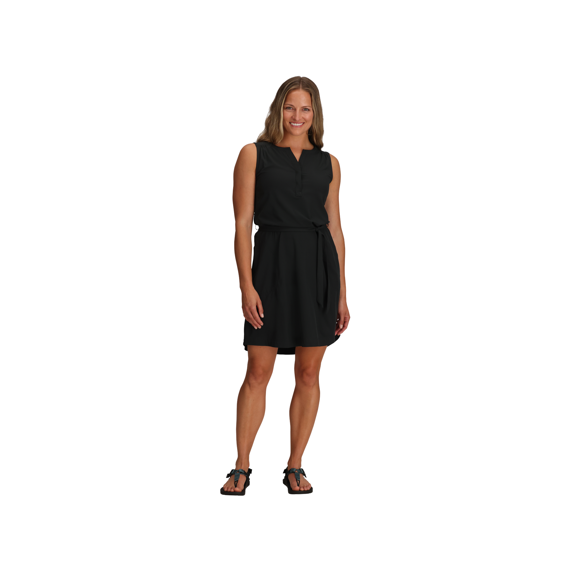 Woman smiling in a Royal Robbins Women's Spotless Traveller Tank Dress - ONLINE ONLY, with tied belt and black sandals.