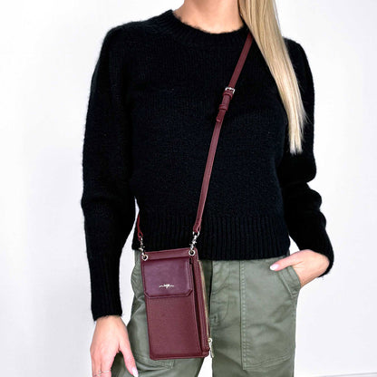 Woman wearing black sweater and wine Espe Zinnie Mini Crossbody, front view