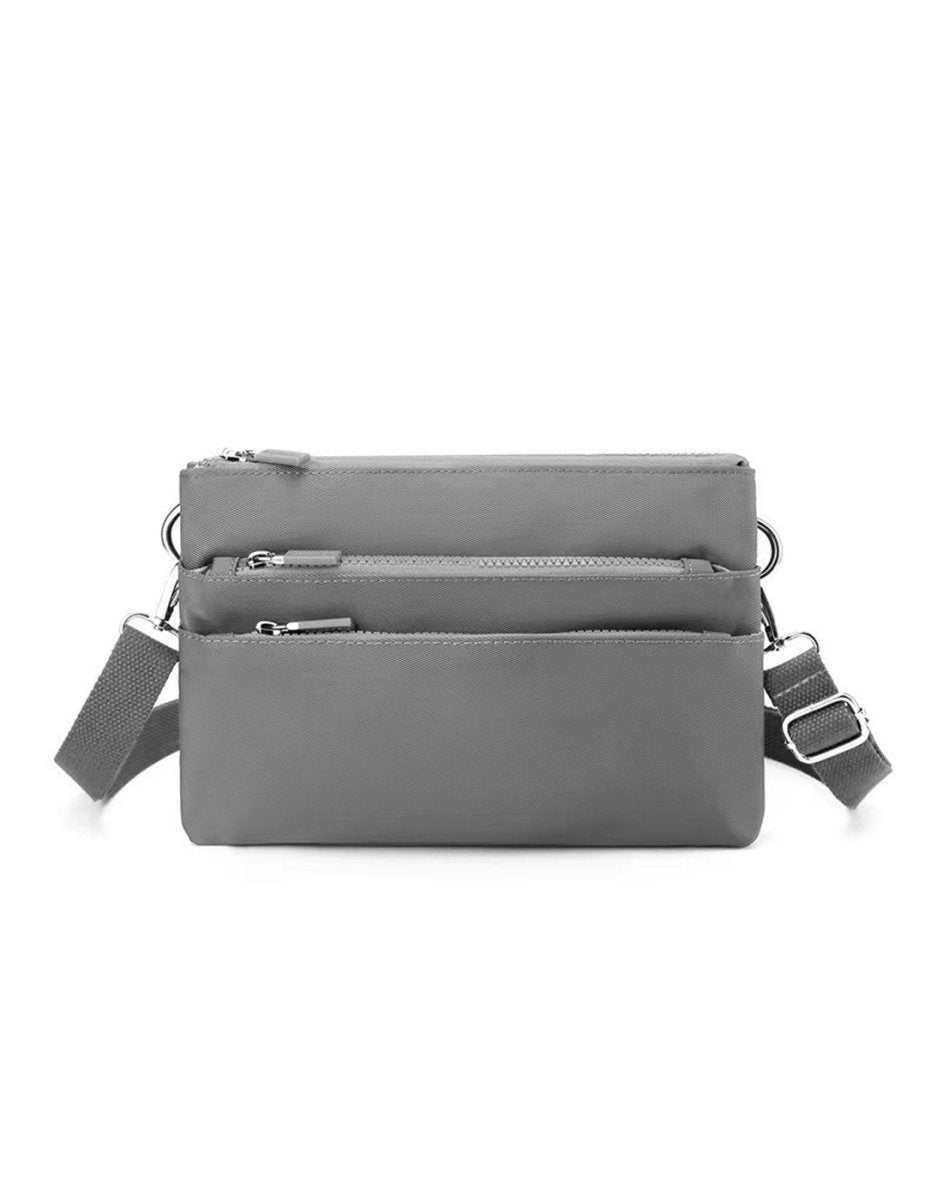 Alina's Triple Compartment RFID Crossbody in grey, front view.