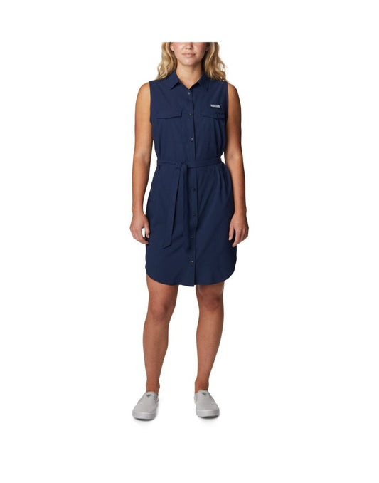 Product Image – Woman wearing light grey running shoes and Columbia Women's PFG Sun Drifter™ Woven Dress II in collegiate navy, front view