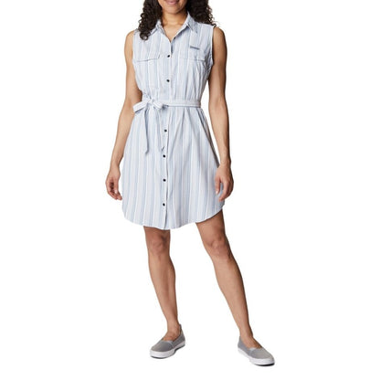 Woman wearing light grey running shoes and Columbia Women's PFG Sun Drifter™ Woven Dress II in carbon vertical stripe, front view