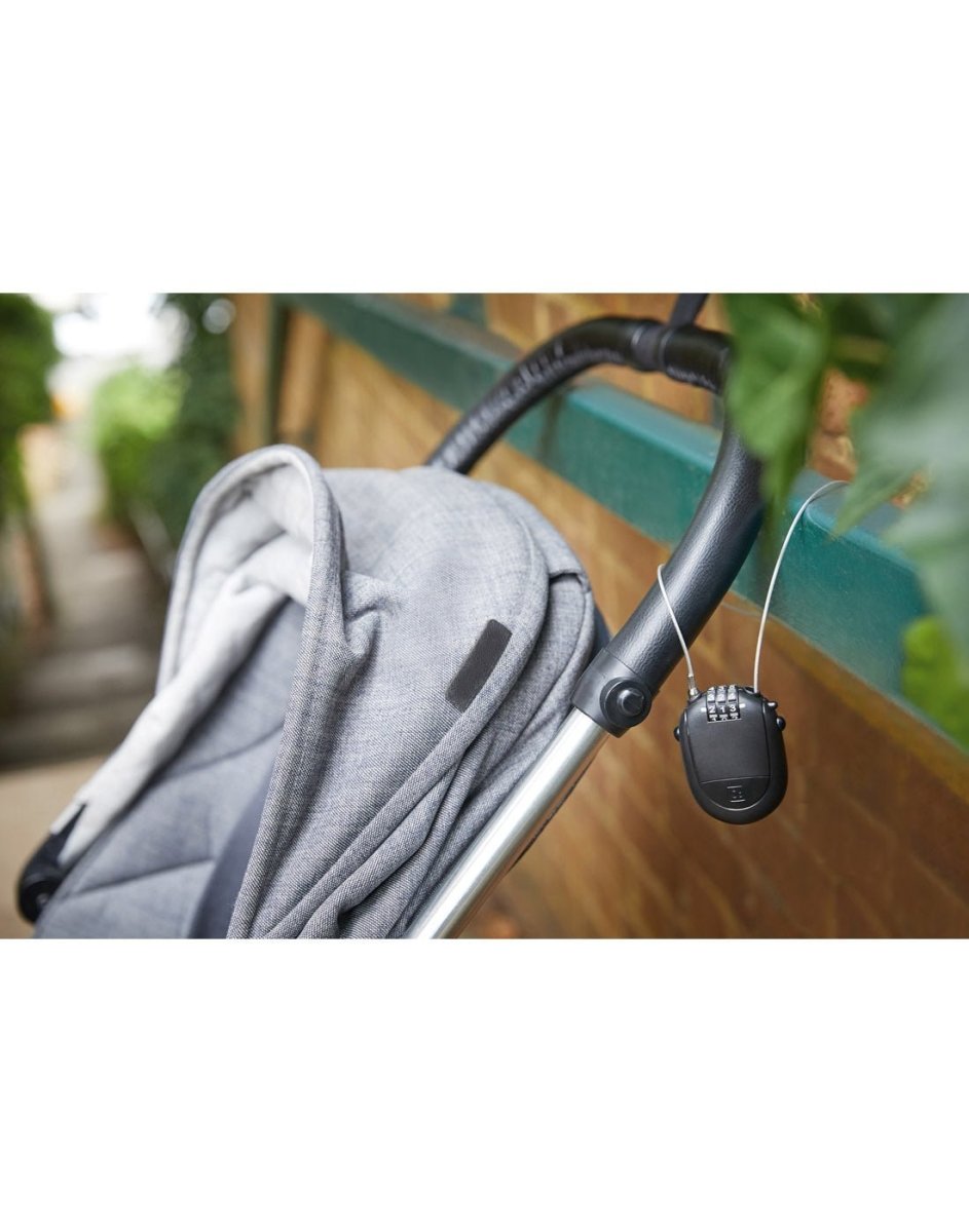 Lifestyle image of a stroller secured to a metal bar using Go Travel Retractable Cable Padlock.