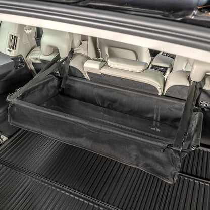 Lifestyle image of High Road® CargoStash™ Storage Shelf, positioned inside the trunk of a car.