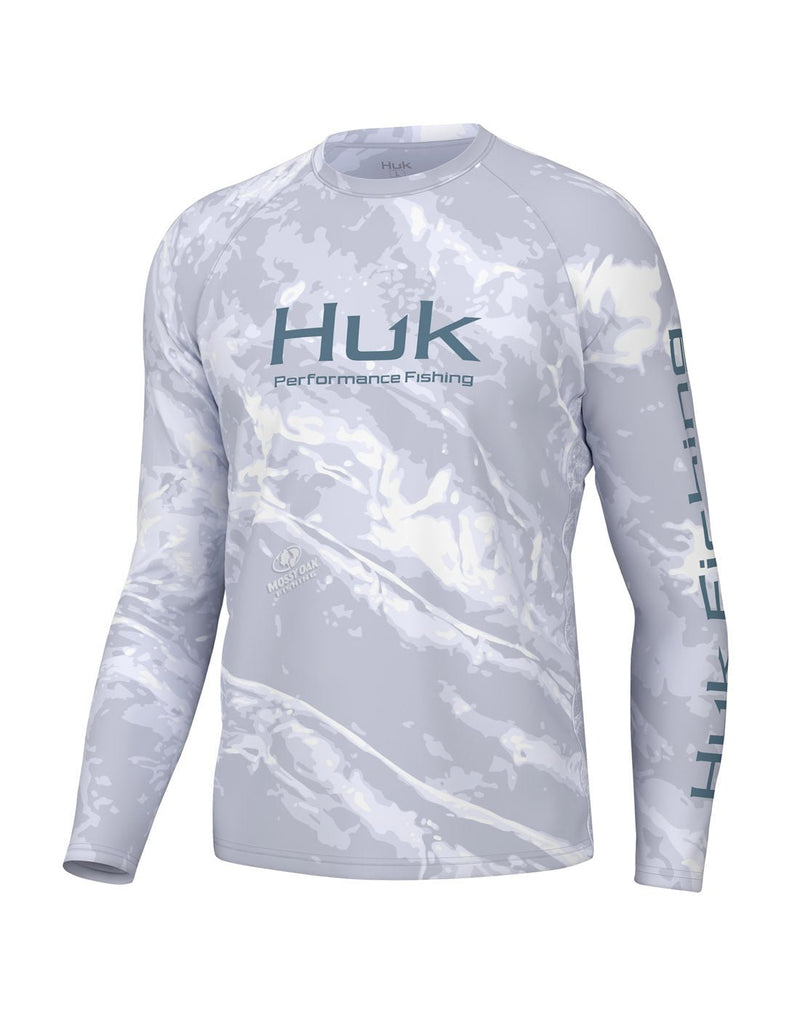 Front view of the Huk Men's Mossy Oak Pursuit Performance Shirt in Mossy Oak Stormwater Bonefish colour.  Huk logo printed across chest and "Huk Fishing" along  outside length of left sleeve.