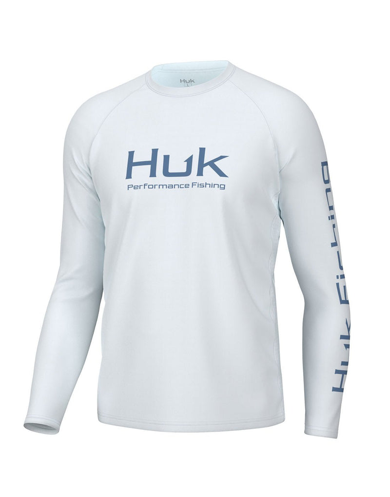 Front view of the Huk Men's Pursuit Performance Shirt  in white. Huk logo printed across chest and "Huk Fishing" along outside length of left sleeve.