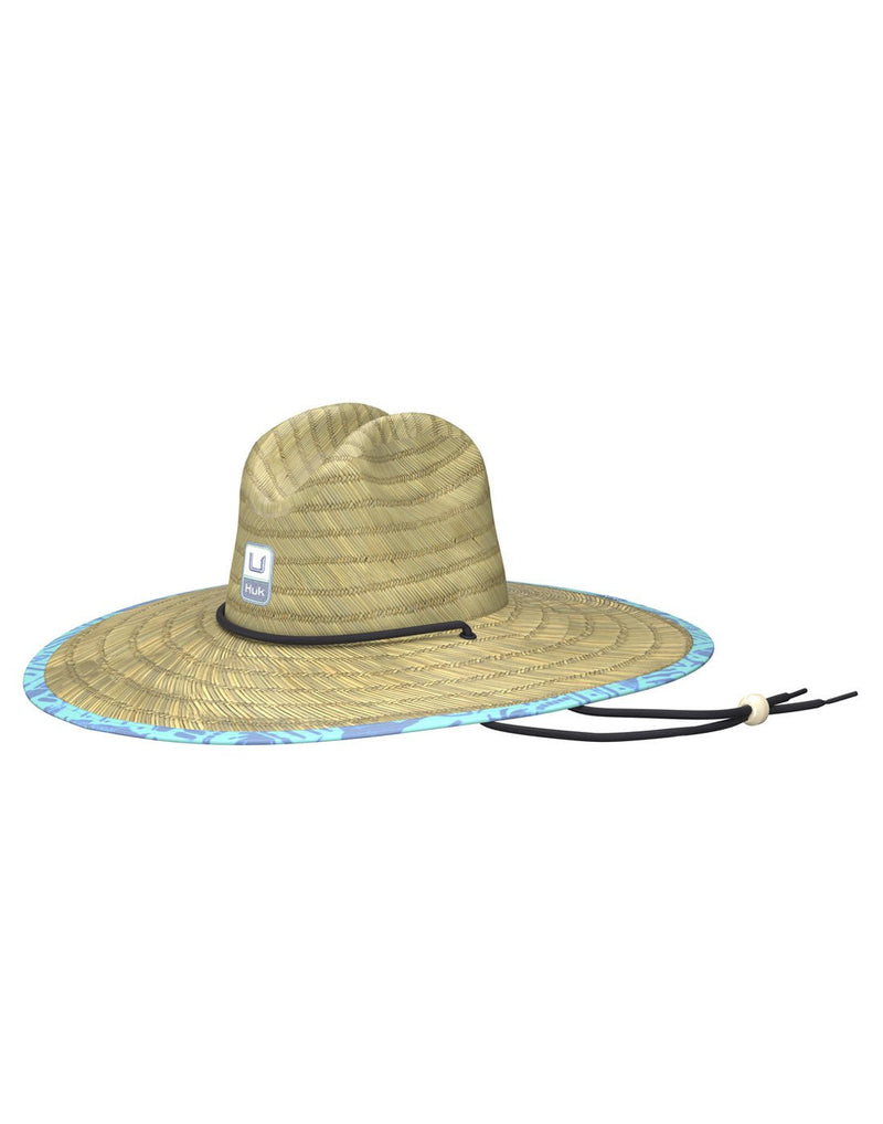 Front view of the Huk Men's Straw Hat in Tiki Beach Marine Blue pattern liner. Showing the Huk logo on the front and the adjustable chin strap.