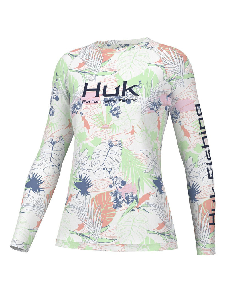 Front view of the Huk Women's Pursuit Performance Shirt in Radical Botanical White colour. Huk logo printed across chest and "Huk Fishing" along outside length of left sleeve.