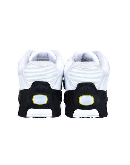 Icetrax IT11 Pro Tungsten Grip Ice Cleats on white sneakers, back heel view