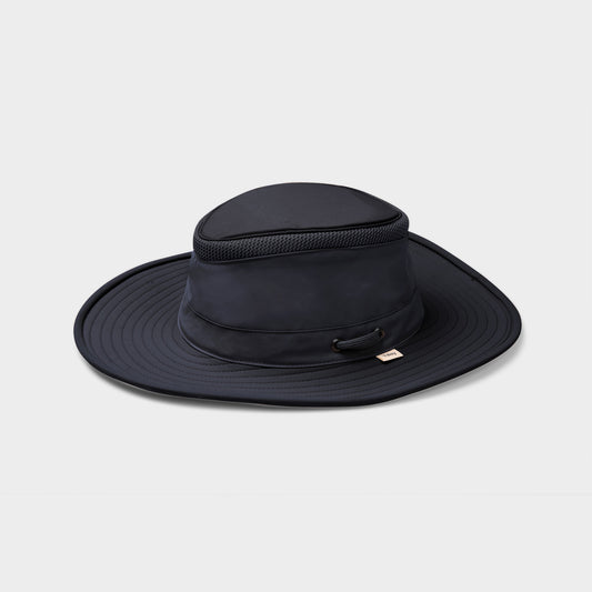 Product Image – The Tilley LTM6 Airflo® Hat by Tilley is a navy blue, recycled nylon wide-brim hat with mesh, shown on white.