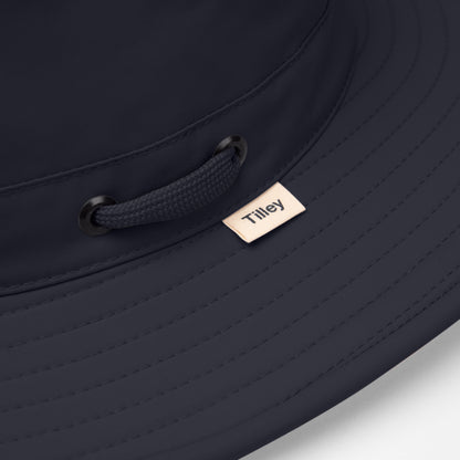 Close-up of the Tilley LTM6 Airflo® Hat in navy, featuring stitched brim, mesh vents, and woven Tilley label.