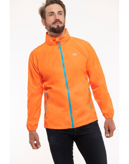 Man wearing Mac in a Sac Origin II Neon Packable Waterproof Jacket in neon orange, front view.