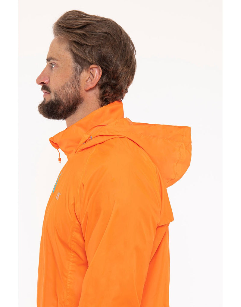 Man wearing Mac in a Sac Origin II Neon Packable Waterproof Jacket in neon orange, close up side view.
