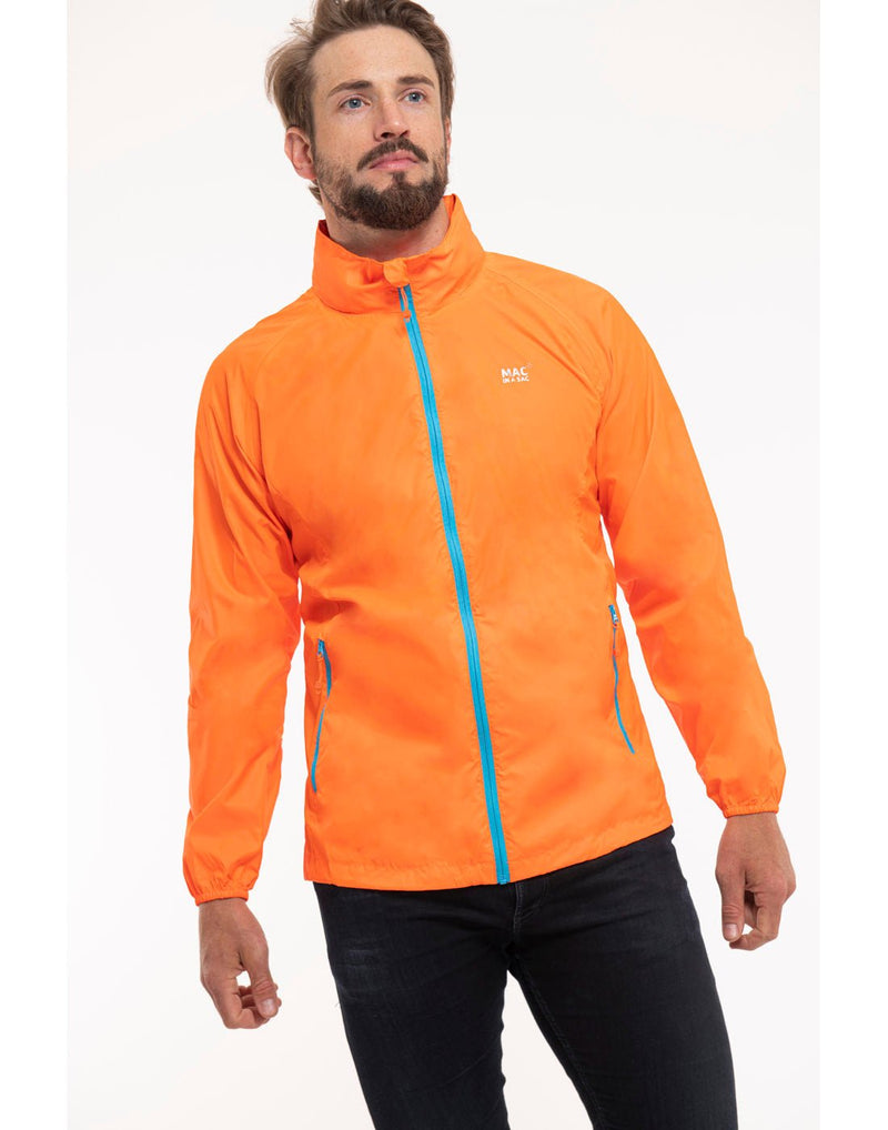 Man wearing Mac in a Sac Origin II Neon Packable Waterproof Jacket in neon orange, front view.