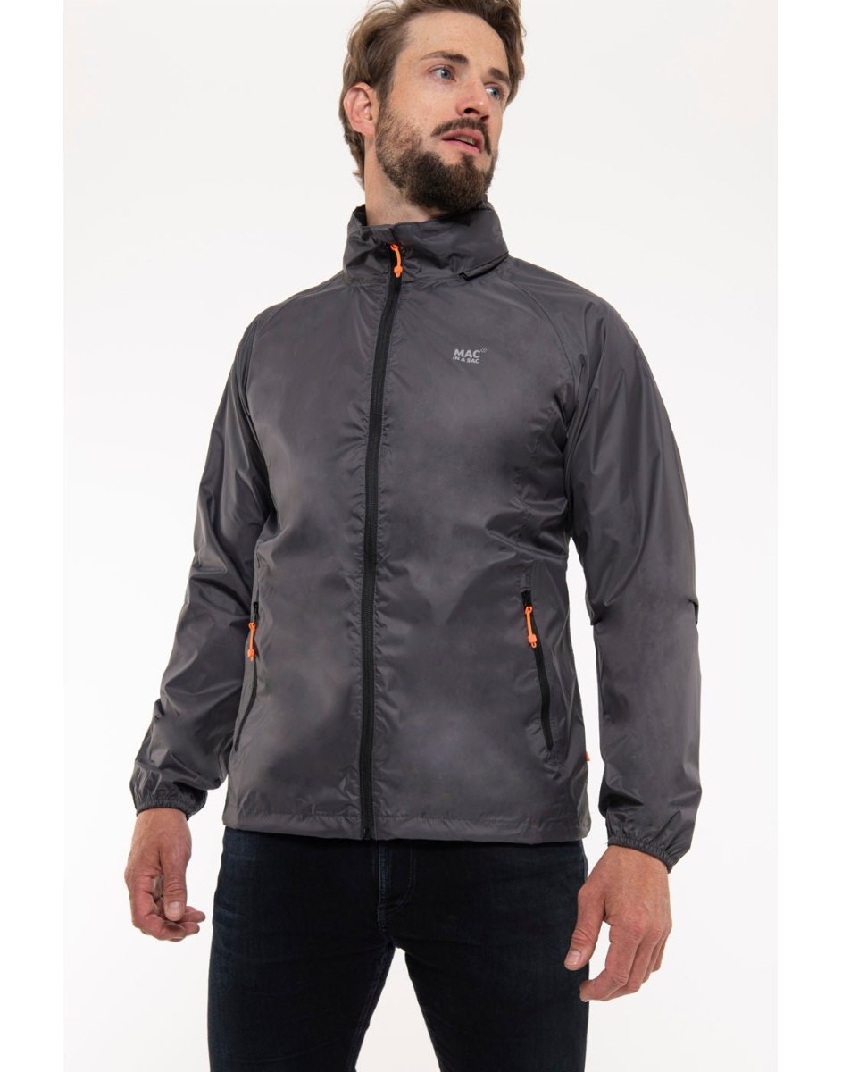 Man wearing Mac in a Sac Origin II Packable Waterproof Jacket in charcoal, front angle view.