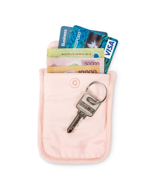 Product Image – Pacsafe Coversafe® S25 Secret Travel Bra Pouch in orchid pink, unbuttoned with cash and credit cards sticking out and a key on top