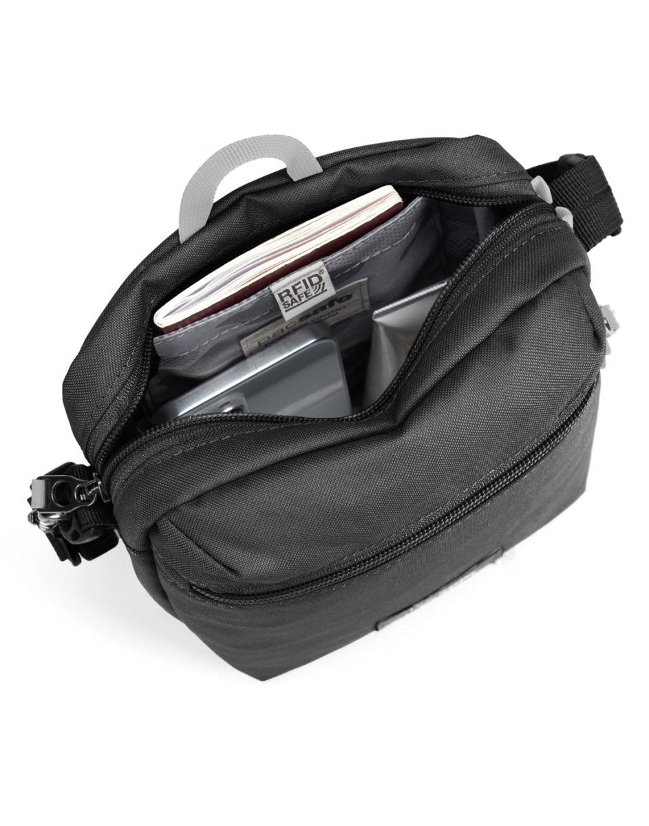 Pacsafe® GO Anti-Theft Festival Crossbody in jet black colour, top view with zipper open showing bag interior and RFID blocking pocket.