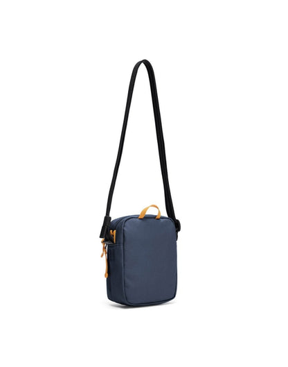 Pacsafe® GO Anti-Theft Micro Crossbody in coastal blue colour, back view with cut-resistant strap extended.