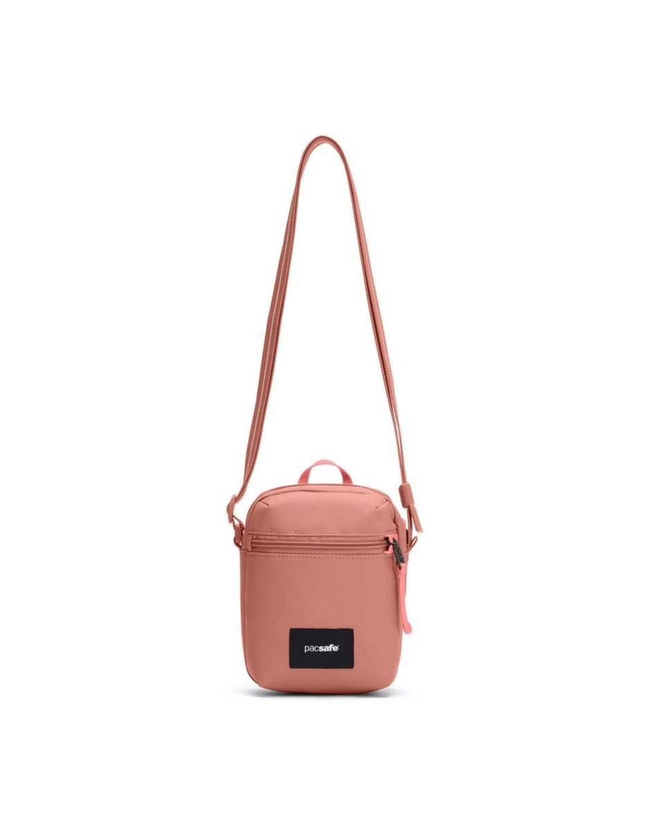 Pacsafe® GO Anti-Theft Micro Crossbody in rose colour, front view with cut-resistant strap extended.