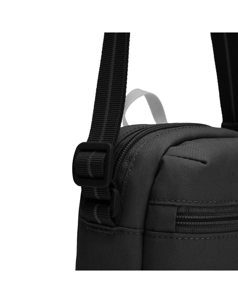 Pacsafe® GO Anti-Theft Micro Crossbody in jet black colour, close up of cut resistant shoulder strap.