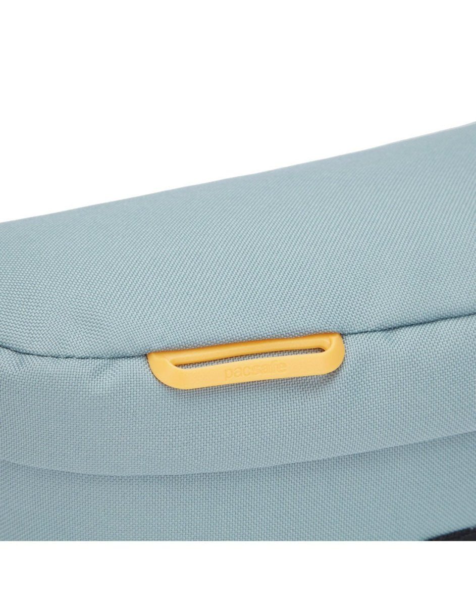 Pacsafe® GO Anti-Theft Sling Pack in fresh mint colour, close up of external attachment point for small items.