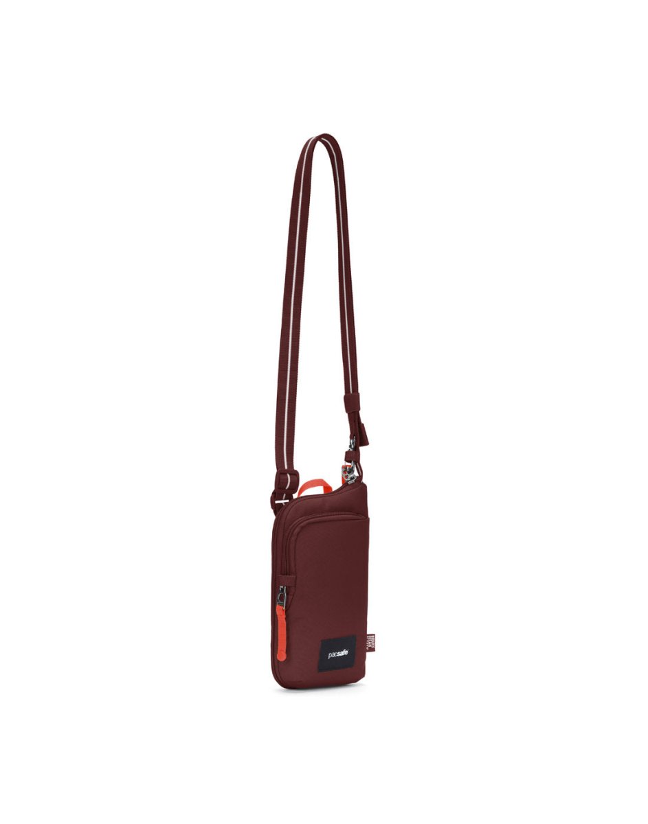 Pacsafe® GO Anti-Theft Tech Crossbody in garnet red, front angled view with Carrysafe® slashguard strap extended.