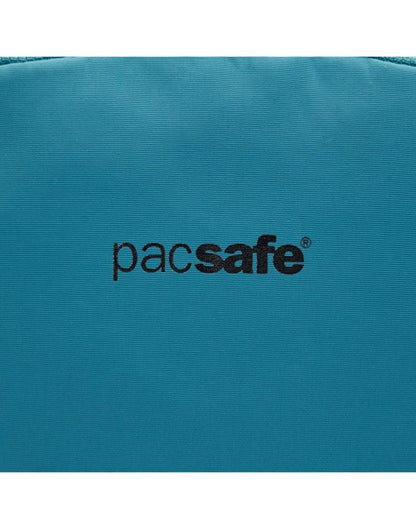 Close up of Pacsafe logo in black on the tidal teal backpack