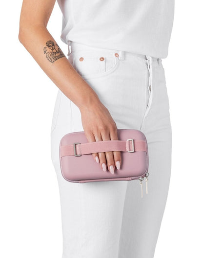 Woman holding the Rollink Mini Bag Tour in Lavender with the back hand strap