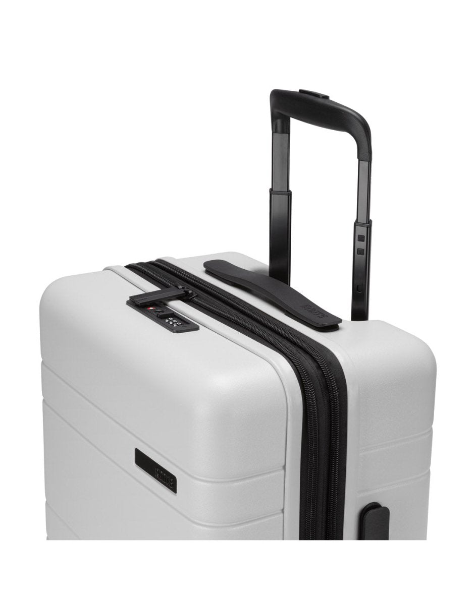 Roots Travel 19" Hardside Spinner Carry-on in antarctica, close-up view of extended luggage handle. 