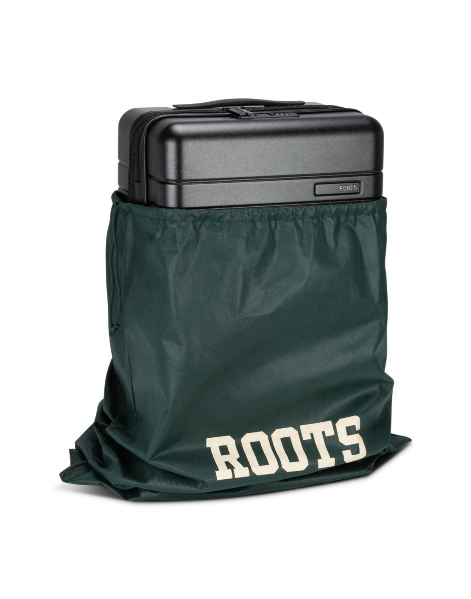 Front angle view of Roots Travel 19" Hardside Spinner Carry-on in black, placed in a Roots bag.