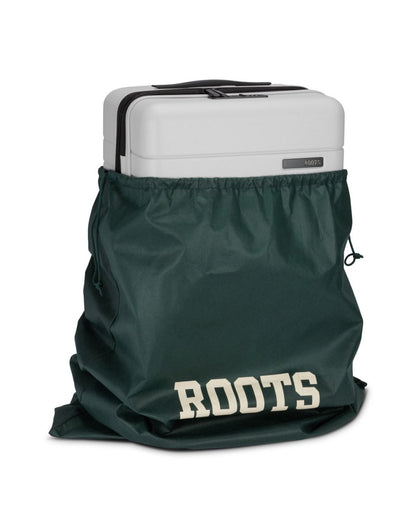 Front angle view of Roots Travel 19" Hardside Spinner Carry-on in antarctica, placed in a Roots bag.