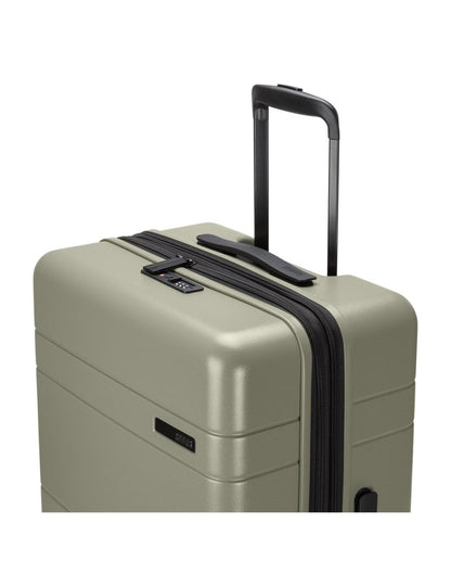 Roots Travel 24" Expandable Hardside Spinner in sage, close-up view of extended luggage handle.