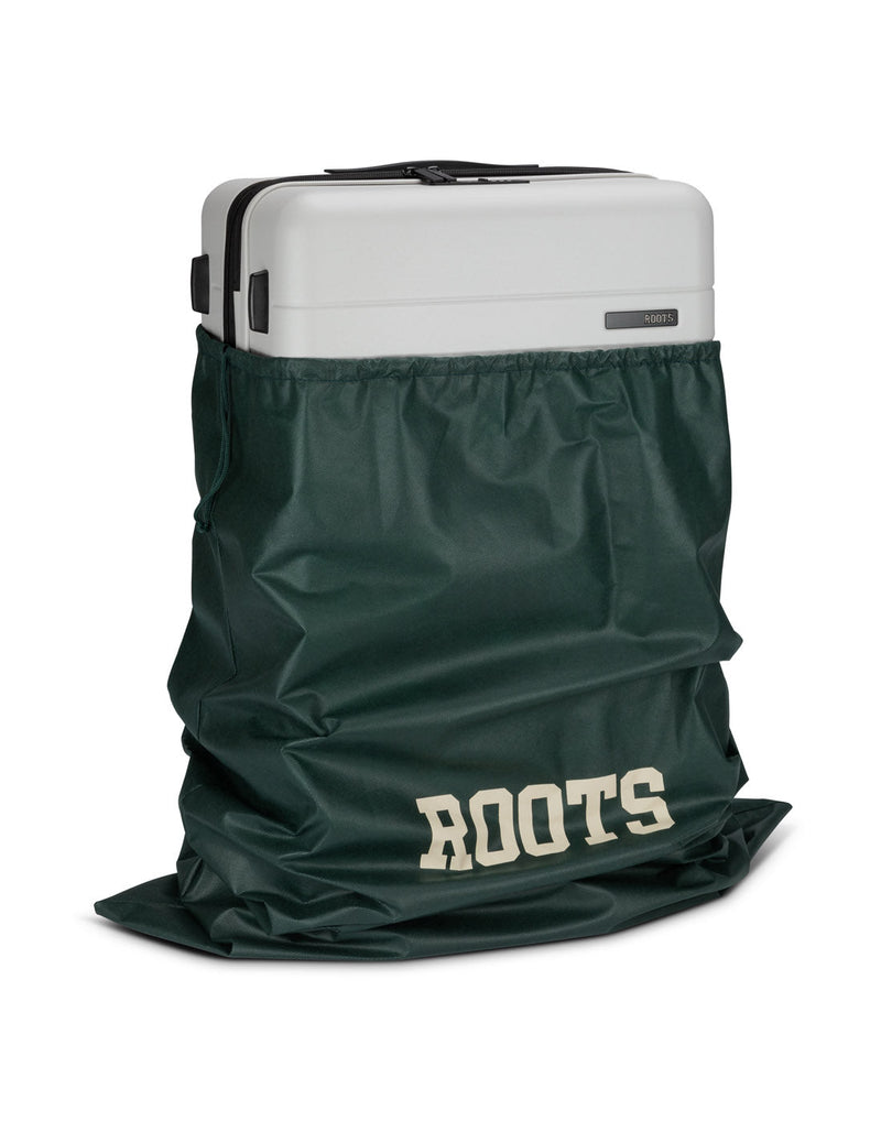 Front angle view of Roots Travel 24" Expandable Hardside Spinner in antarctica, placed inside a Roots bag.